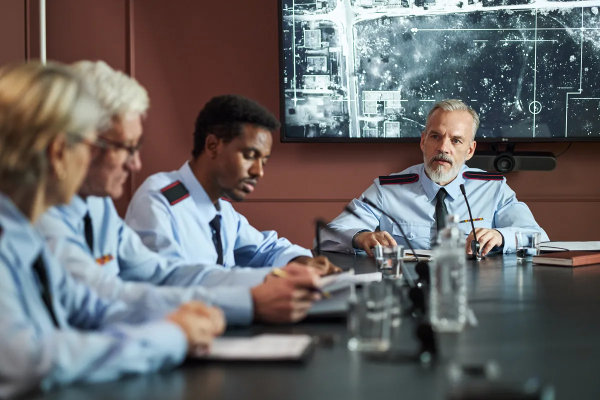 Government officials in a secure CMMC briefing room