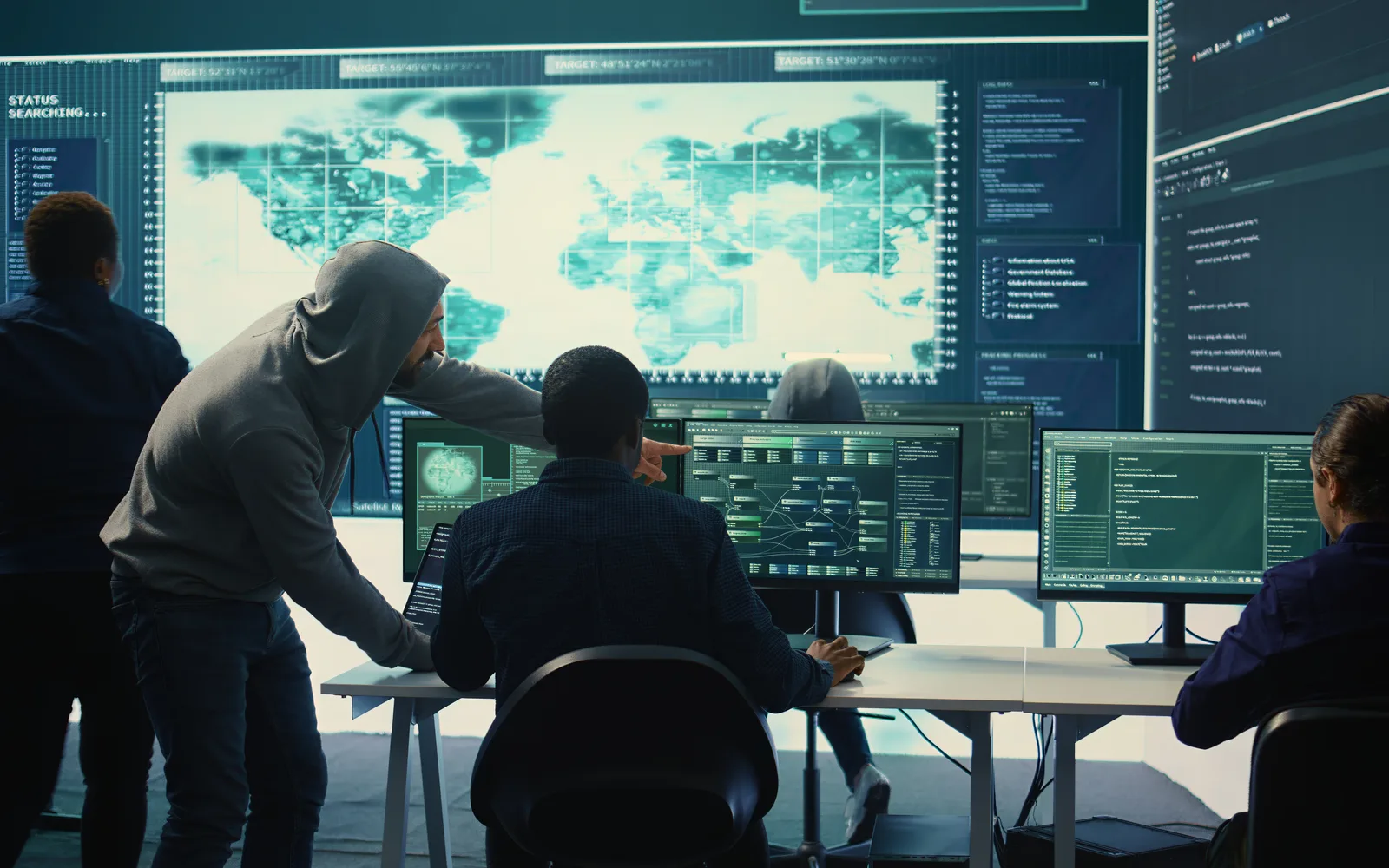 Cybersecurity analysts reviewing global threat activity in a security operations center