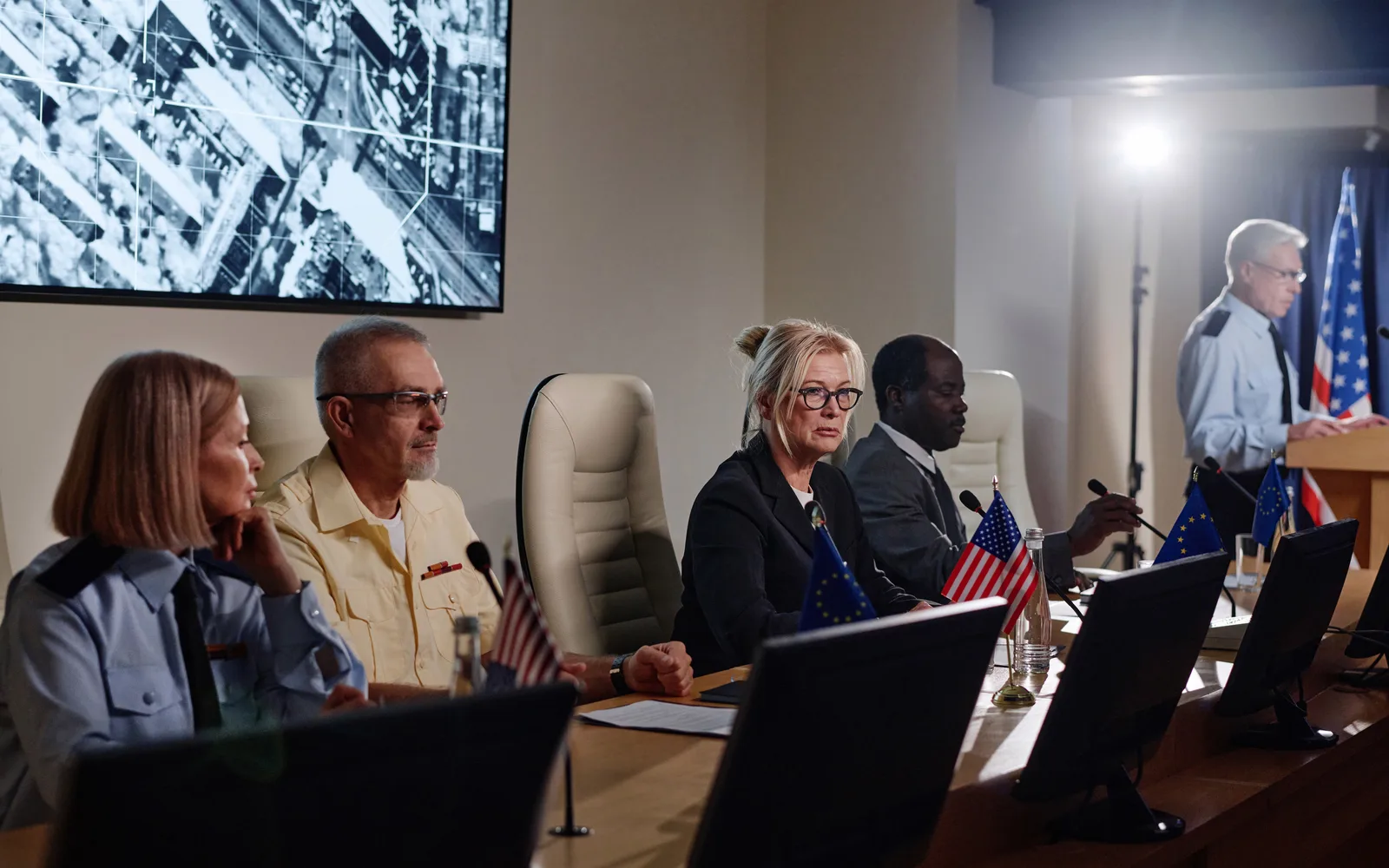 Officials presenting cybersecurity status in an executive briefing room