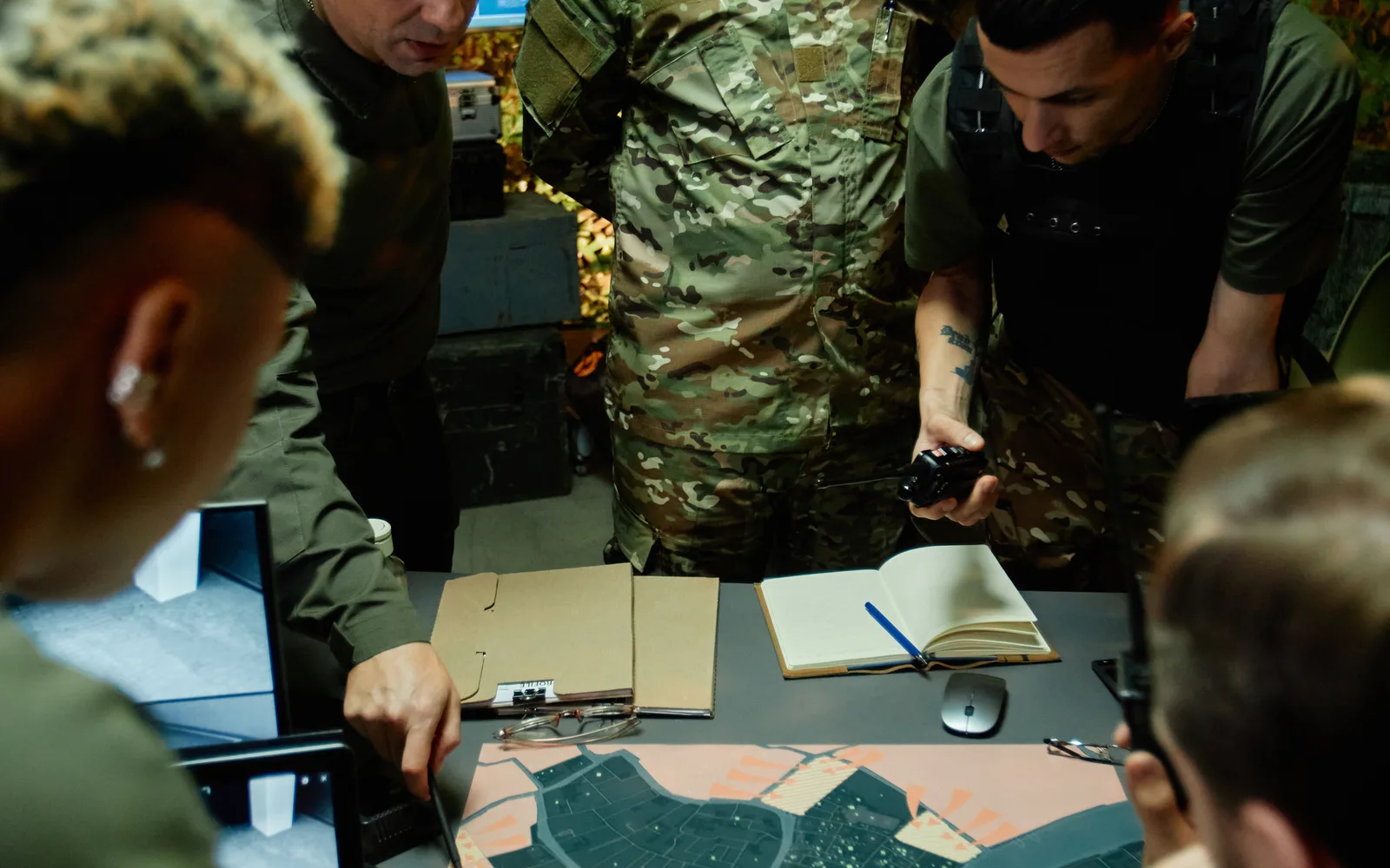 Security team planning an assessment around a map table