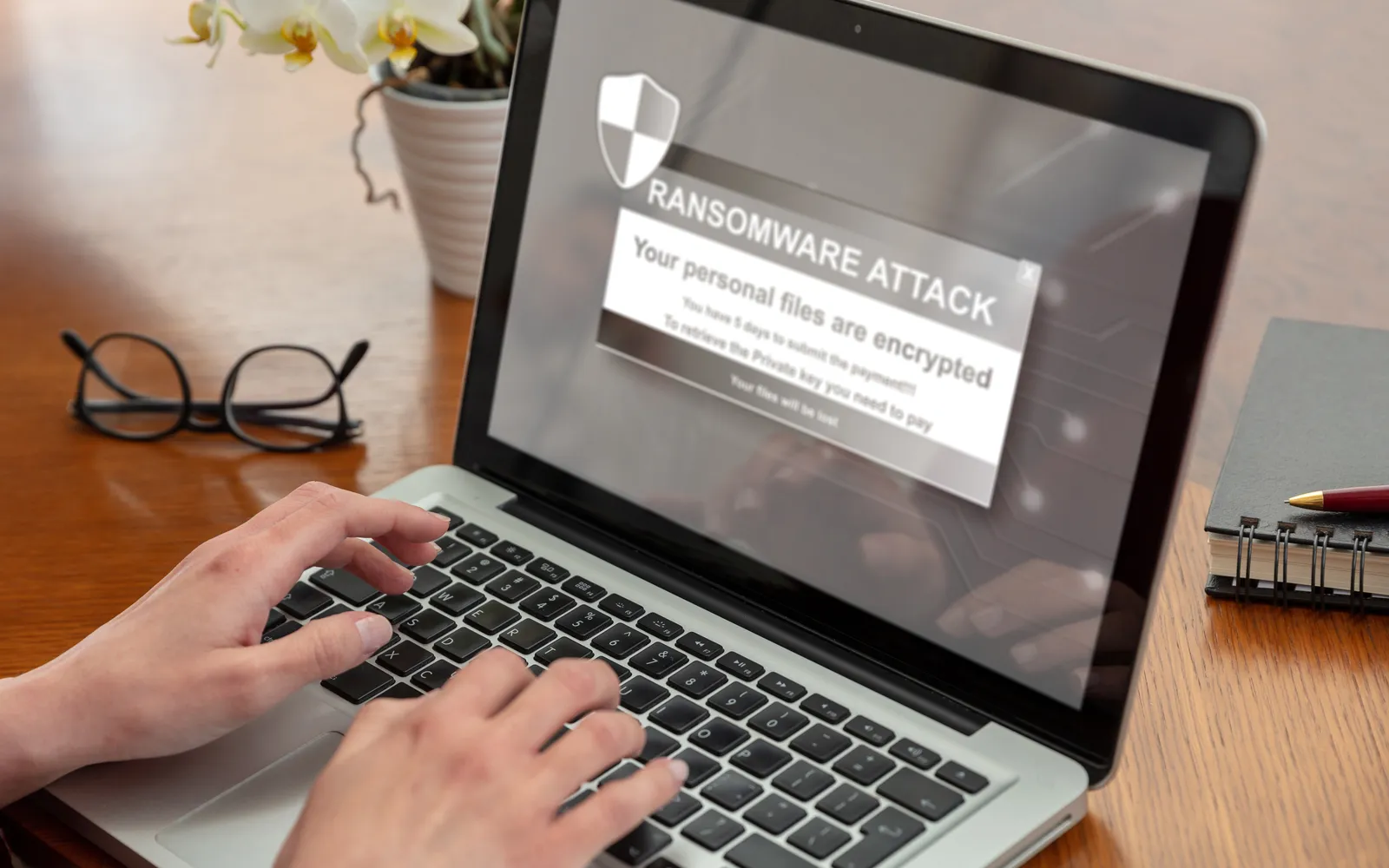 Ransomware attack warning displayed on a compromised laptop